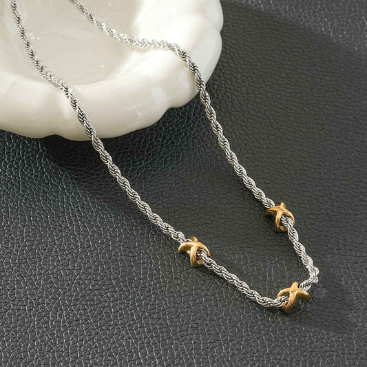 COSMINA Mixed Metals: Silver Rope Chain Necklace with Triple Mini Gold Criss-Cross Charms